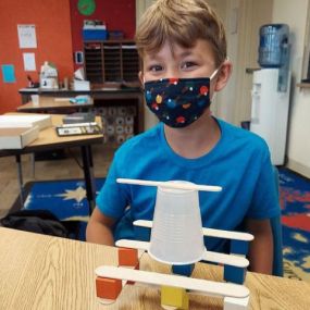 Students in Suite B tackle some engineering challenges— exploring structural design by making a tower out of popsicle sticks, blocks and cups.