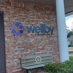 Exterior of Wellby Financial with bench in Friendswood