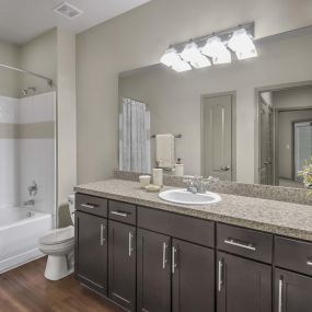 Bathroom with bathtub with tile surround and curved shower rod