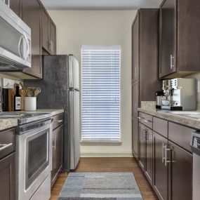 Kitchen with granite style countertops and wood look flooring