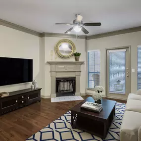 Living room with fireplace and entry to private balcony