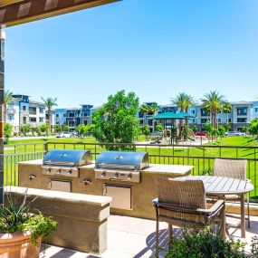 Outdoor barbecue grilling stations with dining areas near playground