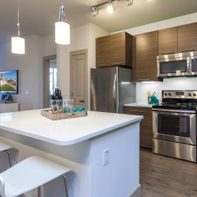 Kitchen with stainless steel appliances and island with space for bar stool seating