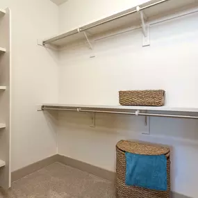 Walk in closet with built in shelves and hanger rods