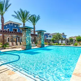 Large resort style pool with lounge and seating areas