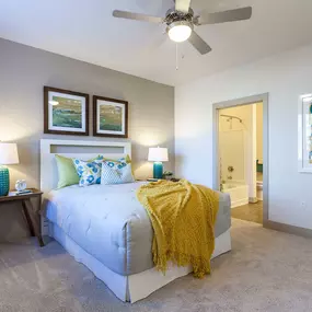 Bedroom with crown molding and lighted ceiling fan and ensuite bathroom