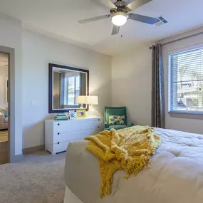 Large bedroom with crown molding and lighted ceiling fan