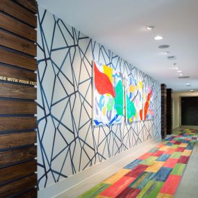 Hallway outside resident clubroom with colorful decor