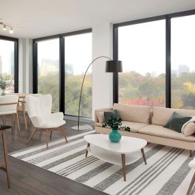 Living room with floor-to-ceiling windows and city views