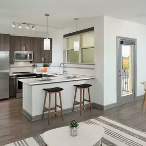 Kitchen with white quartz countertops and open concept living and dining area