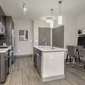 Kitchen with island dishwasher and glass cooktop with flex space