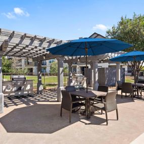 Poolside grills and covered seating at Camden Cedar Hills apartments in Austin, TX