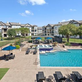 Resort-style pool and sundeck at Camden Cedar Hills apartments in Austin, TX