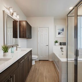 Townhome bathroom with two sinks, walk-in shower and bathtub at Camden Cedar Hills