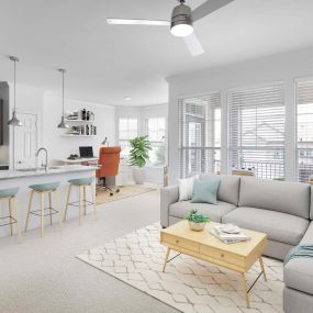 Open-concept living room and kitchen with large windows providing natural light