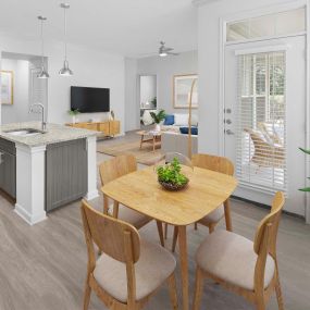 First-floor dining area with wood-style flooring and private patio access