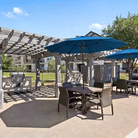 Poolside grills and covered seating at Camden Cedar Hills apartments in Austin, TX