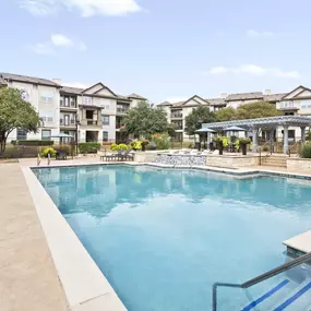 Resort-style pool with lounge seating at Camden Cedar Hills apartments in Austin, TX