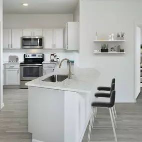 Kitchen with quartz countertops large kitchen pantry and stainless appliances