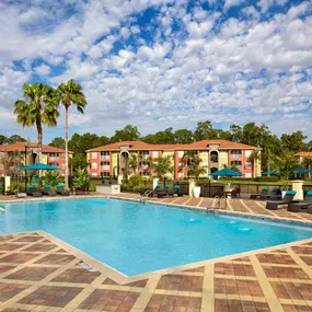 Pool with large sundeck overlooking lake with fountain