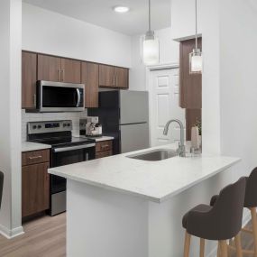 Kitchen with gray quartz countertops at Camden Vanderbilt Apartments in Houston, Texas