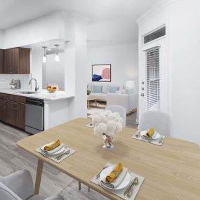 Modern Finish kitchen and dining area with dark brown cabinetry and stainless steel appliances at Camden Vanderbilt Apartments in Houston, TX