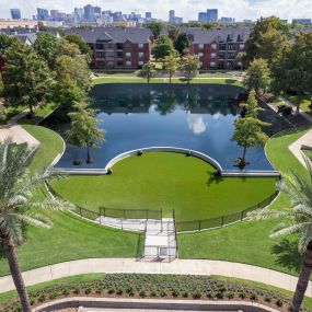 Dog park and lake at Camden Vanderbilt Apartments in Houston, Texas