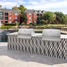 BBQ grills by the pool at Camden Vanderbilt apartments in Houston, TX