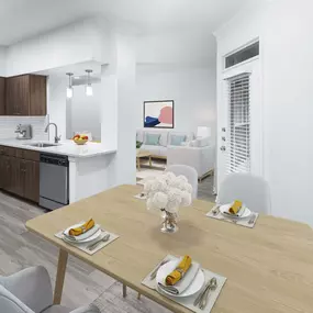 Modern Finish kitchen and dining area with dark brown cabinetry and stainless steel appliances at Camden Vanderbilt Apartments in Houston, TX