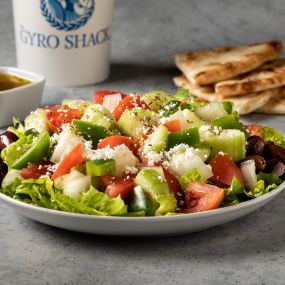 Greek Salad - Romaine lettuce, tomato, cucumber, onion, bell pepper, Kalamata olives, feta cheese, house vinaigrette & pita bread.
