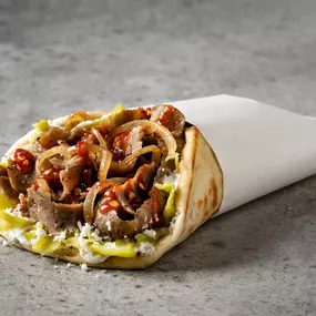 Z Gyro - Gyro meat, Tzatziki sauce, grilled onion, pepperoncini, feta & spicy sauce.