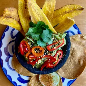 Guacamole Deluxe served with plantain and tortilla chips