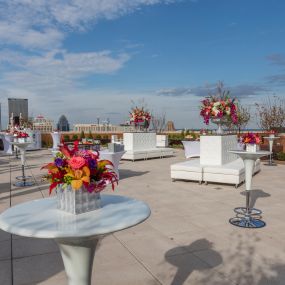 White tables on the rooftop at The Brown Hotel