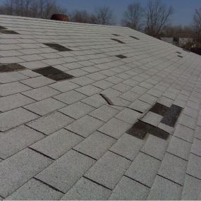 Wind damaged asphalt shingle roof that was a approved for a full roof replacement thru a home insurance claim.