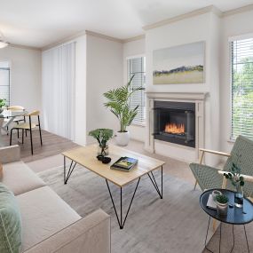Open concept living room with a gas fireplace and dining room area