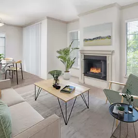 Open concept living room with a gas fireplace and dining room area