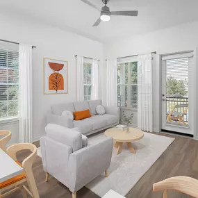 Modern Finish living room with natural light and hardwood-style flooring at Camden Lakeway Apartments in Lakewood, CO