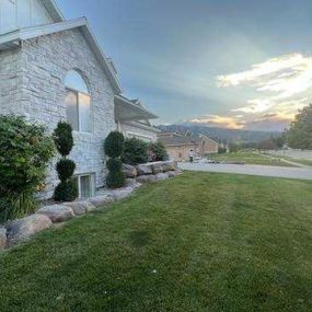 side view of a home with stone installation