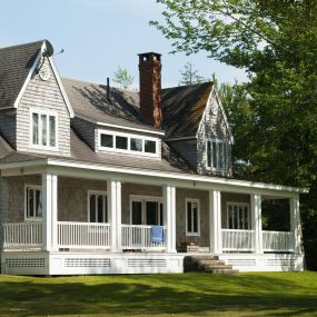 home with a large porch and siding on the windows done by ExterPro