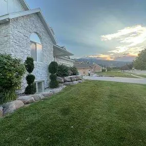 side view of a home with stone installation