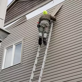 man completing a siding installation service