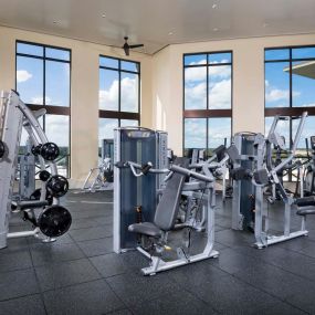 Rooftop fitness center with cardio equipment overlooking lake concord