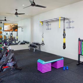 Rooftop fitness center with spin bikes and strength training equipment