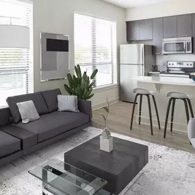 Open-concept living room and kitchen in studio floor plan at Camden North Quarter apartments in Orlando, FL