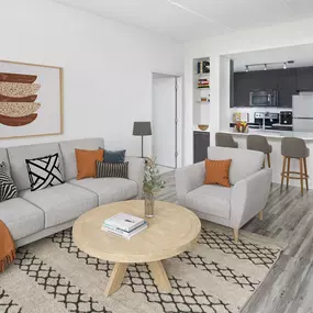 Open-concept kitchen and living room with wood-look flooring at Camden North Quarter apartments in Orlando, FL