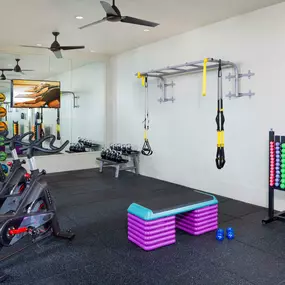 Rooftop fitness center with spin bikes and strength training equipment