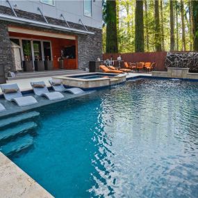 Custom pool with tanning ledge and spa