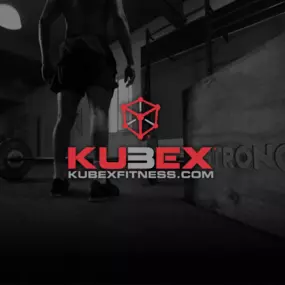 Kubex Fitness man standing by weights