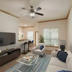 Spacious living room space with bar steading and private patio at Camden Greenway Apartments in Houston, TX