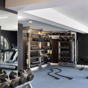 Camden Hillcrest Apartments San Diego CA fitness center with rope trainer dumbbells free weights rowing machine stability balls and kettle bells